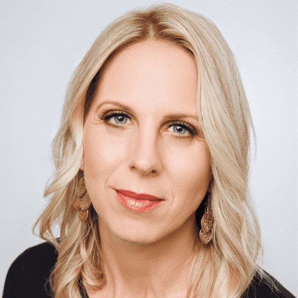 Bright woman with blonde hair, promoting personal growth at New Living Expo.