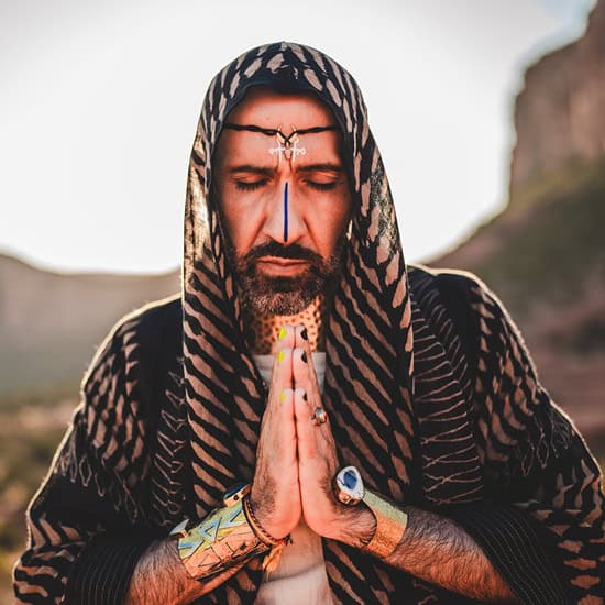 Meditating man with sacred markings at New Living Expo.