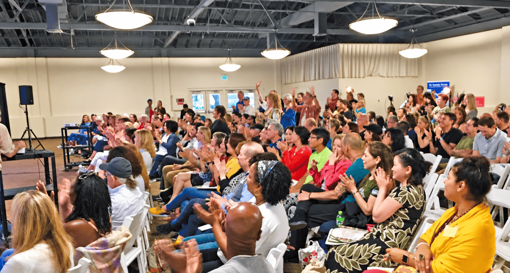 New Living Expo audience celebrating and connecting at a live event