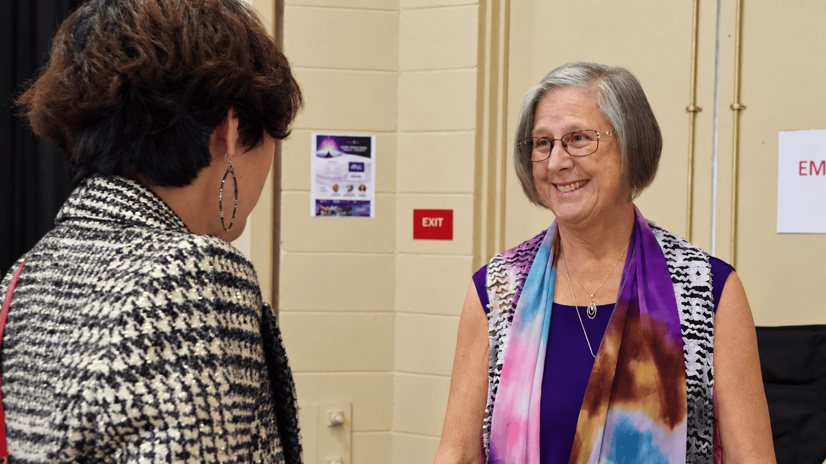 Two attendees sharing a warm conversation at a past New Living Expo